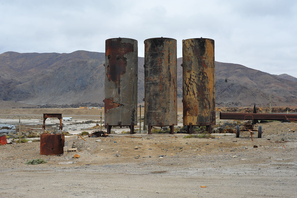 Rusted industrial tanks on a contaminated site
